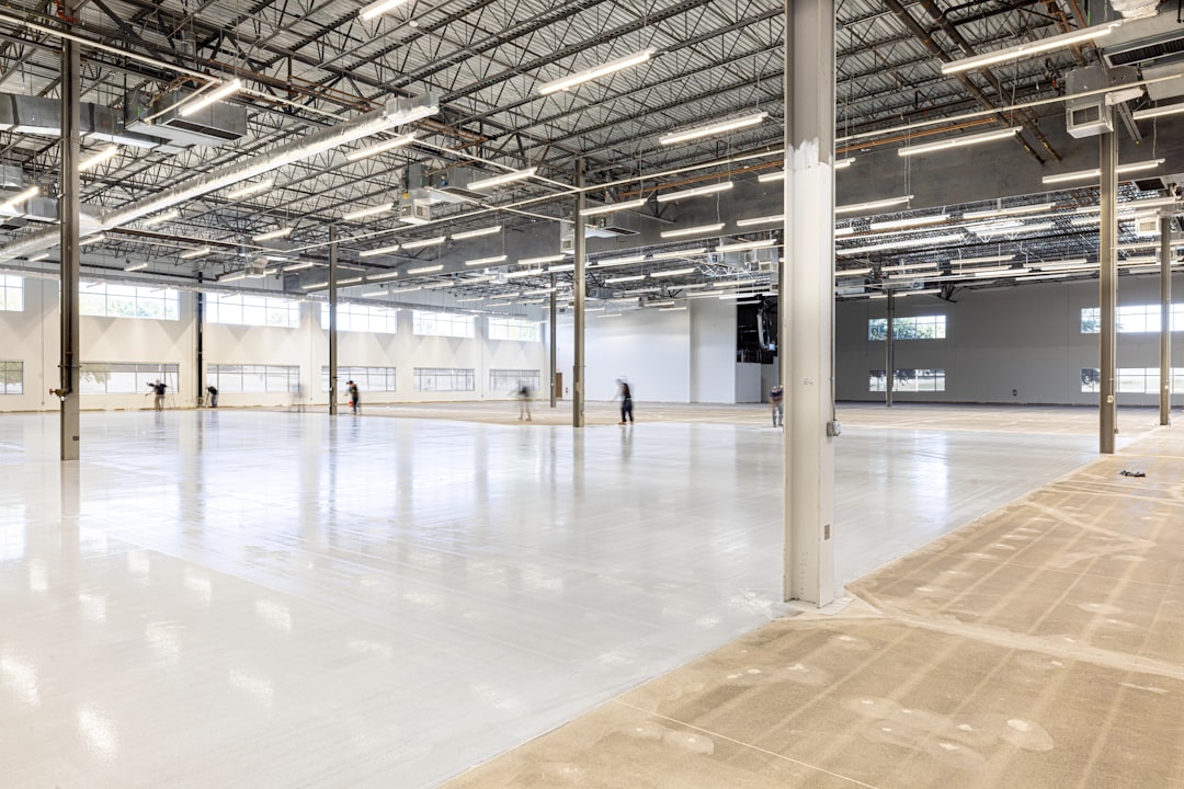 portfolio-01 Craftsman Concrete Floors crew actively applying a specialized ESD epoxy flooring system in a Houston commercial facility. This job site progress shot captures workers smoothing the seamless, static-control surface engineered for mission-critical Energy-to-Compute (E2C) environments. View technical specs: craftsmanconcretefloors.com/esd-flooring/